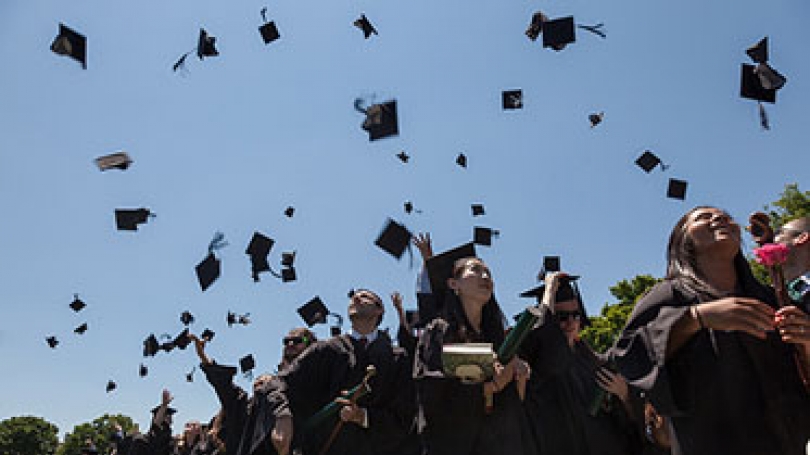 Mortarboards in the air at Commencement.