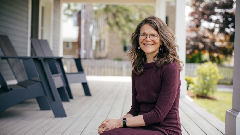 Prof Kathryn Lively sits on the porch of her home
